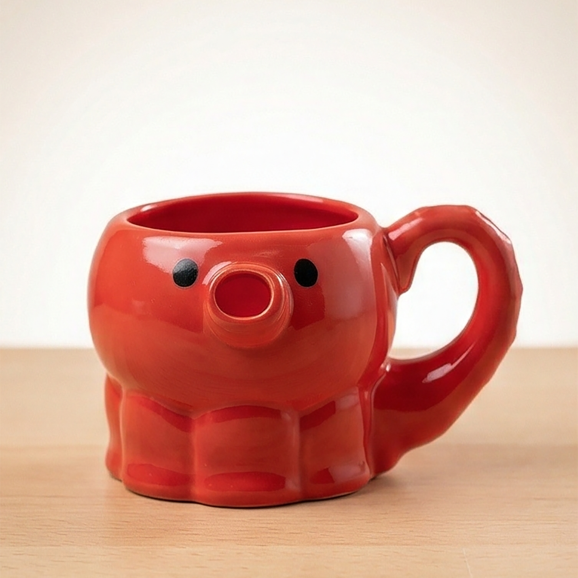 Rotes keramisches Takoyaki-Oktopus Teigkännchen von vorne mit schwarzen Augen und rundem Mund als Ausgießer